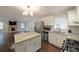 Modern kitchen connected to living room featuring stainless appliances, granite counters, and white cabinets at 1322 Lorenzo Sw Dr, Atlanta, GA 30310
