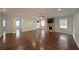 Open living room featuring hardwood floors, stone fireplace, and great natural light at 1322 Lorenzo Sw Dr, Atlanta, GA 30310