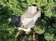 Overhead view of a home with a complex roofline, nestled among dense trees at 18 Commerce Row, Cartersville, GA 30121