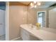A bright bathroom with white sink, large mirror, and neutral wall color at 18 Commerce Row, Cartersville, GA 30121