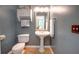 Charming half bathroom with a pedestal sink, decorative mirror, and neutral color scheme at 18 Commerce Row, Cartersville, GA 30121
