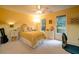 Bright bedroom with yellow walls features a comfy bed and natural light at 18 Commerce Row, Cartersville, GA 30121
