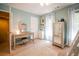 This bedroom features light blue walls, a desk with vanity, and a neutral rug at 18 Commerce Row, Cartersville, GA 30121