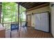Cozy deck with seating and storage overlooking a green, tree-filled landscape at 18 Commerce Row, Cartersville, GA 30121