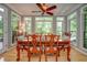 Sunlit dining room boasting a formal dining table and views of the serene surrounding nature at 18 Commerce Row, Cartersville, GA 30121