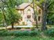 Lovely home with a stone facade and pathway, surrounded by mature trees and greenery at 18 Commerce Row, Cartersville, GA 30121