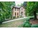 Beautiful home nestled among lush trees, showcasing a stone and stucco exterior at 18 Commerce Row, Cartersville, GA 30121