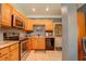 A modern kitchen featuring wooden cabinetry and stainless steel appliances at 18 Commerce Row, Cartersville, GA 30121