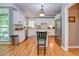 Bright kitchen with wooden floors, white cabinets, stainless appliances, and a kitchen island at 18 Commerce Row, Cartersville, GA 30121