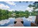 Picturesque lake view featuring a private dock, mature trees, and serene water reflections at 18 Commerce Row, Cartersville, GA 30121