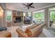 Comfortable living room with a stone fireplace, large windows, and access to the outdoor deck at 18 Commerce Row, Cartersville, GA 30121