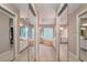 Main bathroom featuring large mirrors, tile floors, soaking tub and double vanities at 18 Commerce Row, Cartersville, GA 30121