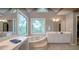 Main bathroom featuring tile floors, soaking tub, double vanities and bright windows at 18 Commerce Row, Cartersville, GA 30121