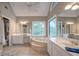 Main bathroom featuring tile floors, soaking tub, double vanities and a window with a backyard view at 18 Commerce Row, Cartersville, GA 30121
