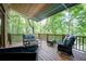 Relaxing deck space with comfortable seating and a view of the surrounding trees at 18 Commerce Row, Cartersville, GA 30121
