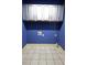 This laundry room is painted in a calming blue hue and features overhead cabinets at 2313 Bouldercliff Way, Atlanta, GA 30316