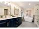 A bright bathroom with double sink vanity, soaking tub, and glass shower, offering a luxurious space at 2691 Jamerson Rd, Marietta, GA 30066