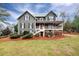 Charming two-story home with covered porch, a red door, and a beautifully landscaped front yard at 2691 Jamerson Rd, Marietta, GA 30066