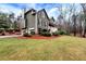 Two-story home with green siding, a large yard, and an attached garage at 2691 Jamerson Rd, Marietta, GA 30066