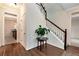 Inviting foyer features hardwood floors, staircase with white railings, and view into the kitchen at 2691 Jamerson Rd, Marietta, GA 30066