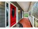 Covered front porch with a red front door, classic columns, and wood flooring at 2691 Jamerson Rd, Marietta, GA 30066