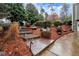 View of stone steps and landscaped front yard with mature trees and a decorative planting bed at 2691 Jamerson Rd, Marietta, GA 30066