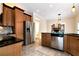 Modern kitchen features stainless steel appliances, wooden cabinetry, and views into the living room at 2691 Jamerson Rd, Marietta, GA 30066