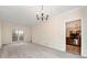Bright living room features neutral carpet, a large window, and an open doorway to the kitchen at 2691 Jamerson Rd, Marietta, GA 30066