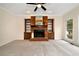 Cozy living room featuring a brick fireplace, built-in shelving, and a large window at 2691 Jamerson Rd, Marietta, GA 30066