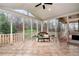 Relaxing screened-in patio featuring tile floors, a comfortable seating area, and wooded views at 2691 Jamerson Rd, Marietta, GA 30066