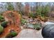 Outdoor stone patio and walkway leading to a scenic pond with stone waterfall and lush landscaping at 2691 Jamerson Rd, Marietta, GA 30066