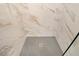 Shower with marble tile and a unique mosaic tile floor at 2691 Jamerson Rd, Marietta, GA 30066