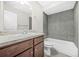 Modern bathroom features a stylish vanity, mirror, and a shower-tub combination with gray tiling at 3100 Parc Lorraine, Lithonia, GA 30038