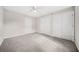Spacious bedroom with plush carpet, neutral walls, and double closets for ample storage at 3100 Parc Lorraine, Lithonia, GA 30038