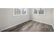 Corner of a bedroom featuring wood-look flooring and two windows providing natural light at 3100 Parc Lorraine, Lithonia, GA 30038