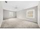 Bright, carpeted bedroom features two windows and neutral paint, creating a cozy and inviting atmosphere at 3100 Parc Lorraine, Lithonia, GA 30038