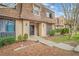 Condominium exterior featuring mature landscaping, sidewalk, and an inviting front entrance at 3100 Parc Lorraine, Lithonia, GA 30038