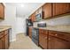 Well-equipped kitchen with wooden cabinets and black appliances, providing functionality and style at 3100 Parc Lorraine, Lithonia, GA 30038