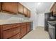 Functional kitchen with ample wood cabinetry and neutral countertops for food preparation and storage at 3100 Parc Lorraine, Lithonia, GA 30038