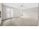 Spacious living room with ample natural light, modern ceiling fan, and a contemporary fireplace at 3100 Parc Lorraine, Lithonia, GA 30038