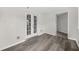 Room with wood-look flooring, neutral walls, French doors, and an open doorway at 3100 Parc Lorraine, Lithonia, GA 30038