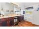 Bright bathroom featuring a soaking tub, double vanity with wood cabinets, and wood flooring at 4270 Holliday Rd, Atlanta, GA 30349