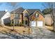 Two-story brick home with a well-manicured lawn and a two-car garage at 4270 Holliday Rd, Atlanta, GA 30349