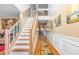 Hallway with hardwood floors, wall trim and adjacent staircase at 4270 Holliday Rd, Atlanta, GA 30349