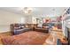 Open concept living room featuring a large sofa, fireplace, and view of the kitchen at 4270 Holliday Rd, Atlanta, GA 30349