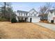 Charming two-story home with light gray siding, dark shutters, a well-manicured lawn, and a two car garage at 3600 Kasner Nw Ct, Kennesaw, GA 30144