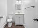 Simple half bathroom with white vanity, toilet, and modern fixtures at 868 Still Hill Ln, Lawrenceville, GA 30045