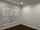 Cozy room featuring wood floors, window with blinds, and neutral wall color at 868 Still Hill Ln, Lawrenceville, GA 30045