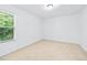 Bright bedroom featuring neutral carpet, large window, and white walls at 868 Still Hill Ln, Lawrenceville, GA 30045