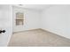 Simple bedroom with neutral carpet and a large window at 868 Still Hill Ln, Lawrenceville, GA 30045